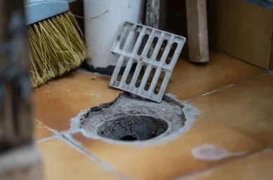 open tile floor drain causing rotten egg sulfur smell in home.
