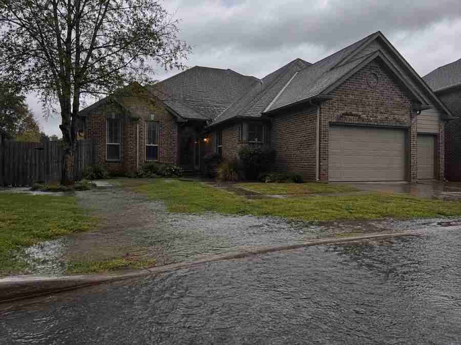 Flooded street in front of a house in Oklahoma City after heavy rainfall.